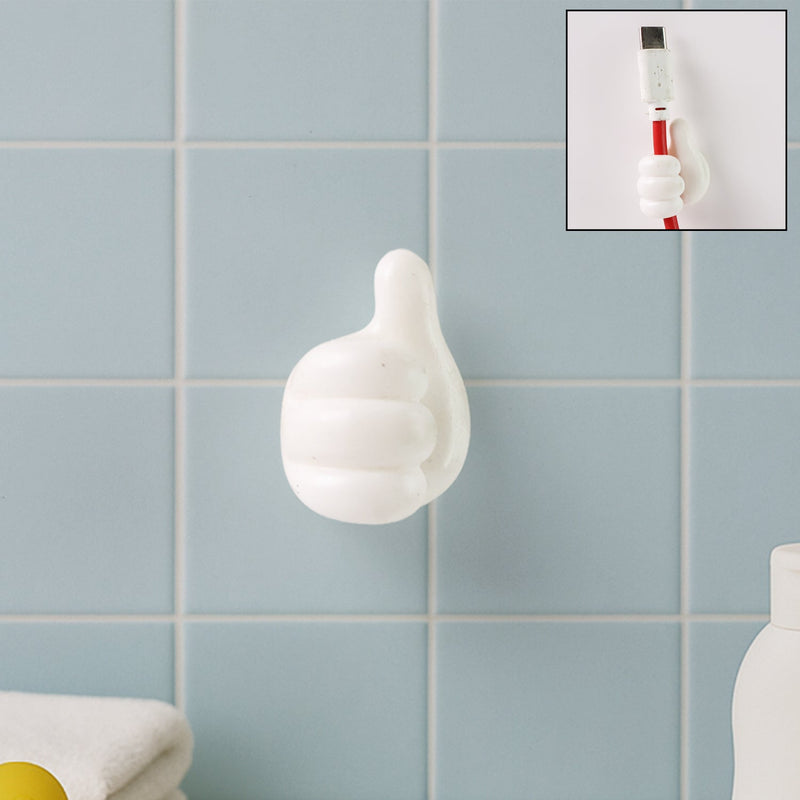 White hand-shaped wall clip holding keys and cables with thumb grip