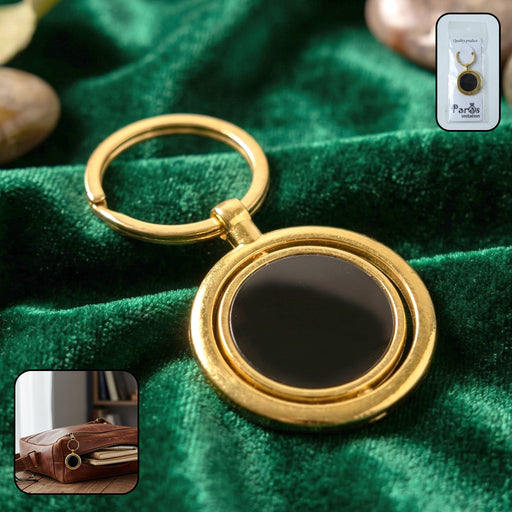 Gold plated keychain with black round rotating pendant, stylish keyring accessory.