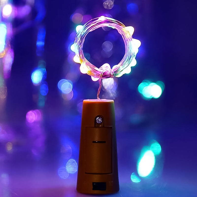 A multi-color LED bottle cork light illuminating an empty wine bottle, creating a festive glow.