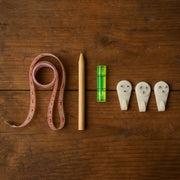 Complete 6-in-1 wall hanging measurement tool kit laid out on table