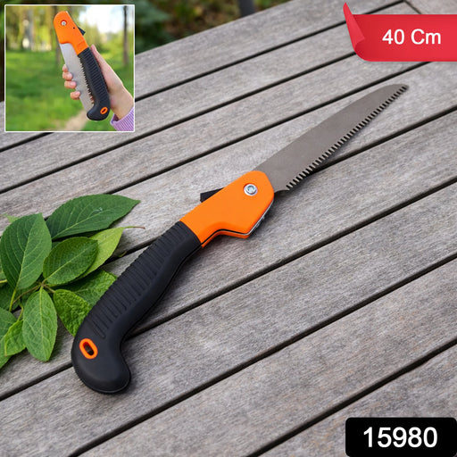Garden hand saw cutting wood branch cleanly with folding blade