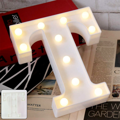 LED Marquee Alphabet Letter Light T glowing softly on table