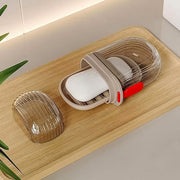 Clear plastic travel soap box with a secure lid, ideal for carrying solid soaps on trips.