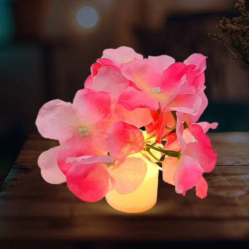 Elegant LED Mood Light with silk flowers in a glass vase, illuminating a modern living space.
