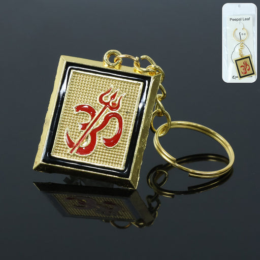 Golden metal Om Trishul keychain front view showcasing intricate spiritual design
