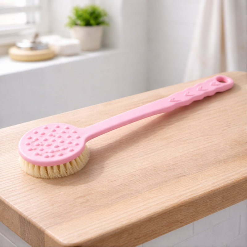 Side view of a pink long handle bath brush, ideal for hard-to-reach areas during shower.