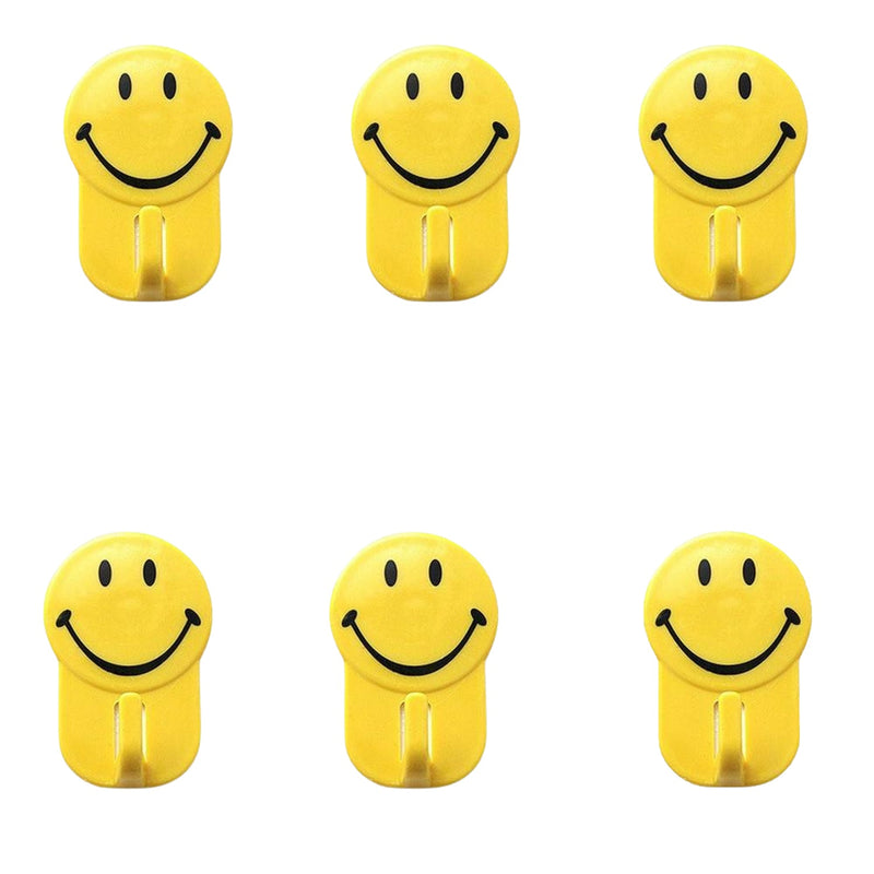 Close-up of a plastic smiley face hook demonstrating its self-adhesive backing.
