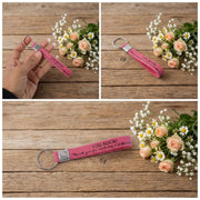 Colorful silicone wrist strap keychain laid out on surface