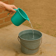 Spill-resistant pouring spout on plastic bath mug
