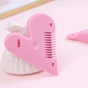 Pink heart-shaped hair cutting scissors with open blades
