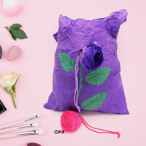 Unfolded reusable shopping bag featuring a vibrant rose design against a plain background.