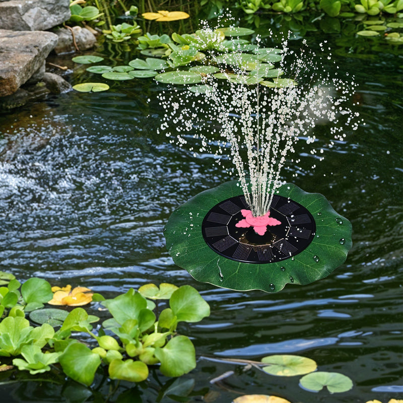 Decorative solar-powered floating water fountain pump placed on water surface