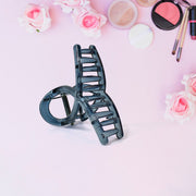 Close-up of matte plastic hair barrette clamp open