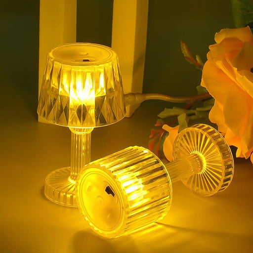 Portable small LED candle lamp with golden bulb light on table