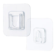 Single clear adhesive hook securely mounted on a smooth wall surface.