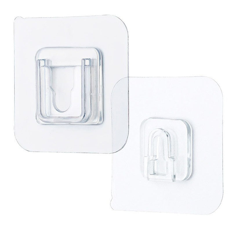 Single clear adhesive hook securely mounted on a smooth wall surface.