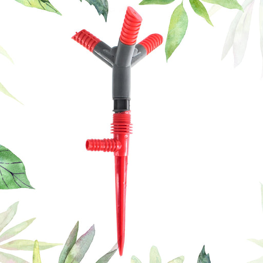  3 arm rotating garden sprinkler top view on lush green grass.