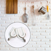 Close-up of a sturdy adhesive wall hook applied to a smooth ceramic tile surface.