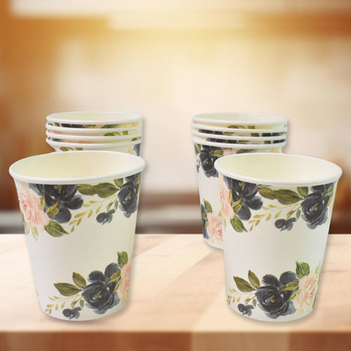 Assorted disposable paper cups in mixed colors and designs for beverages.