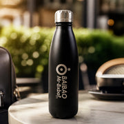 Hand holding the stainless steel water bottle for size reference
