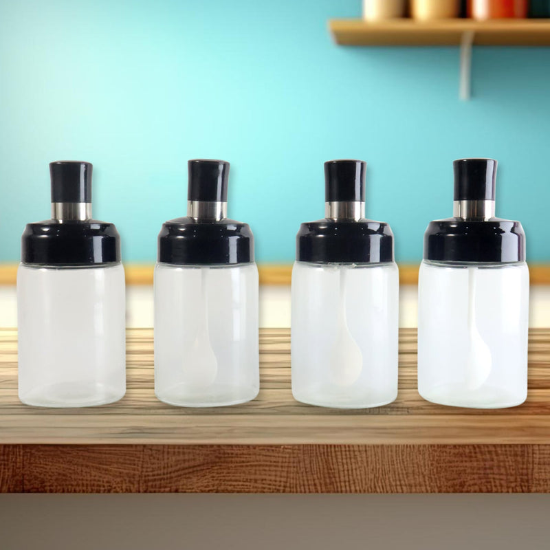 Elegant spice organizer with clear glass jars featuring airtight seals and measuring spoons