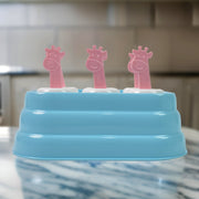 Close-up showing six giraffe-shaped plastic ice mold cavities