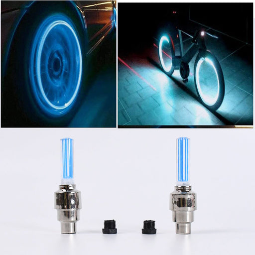 Close-up of glowing mixed-color LED tire valve caps on a vehicle wheel.