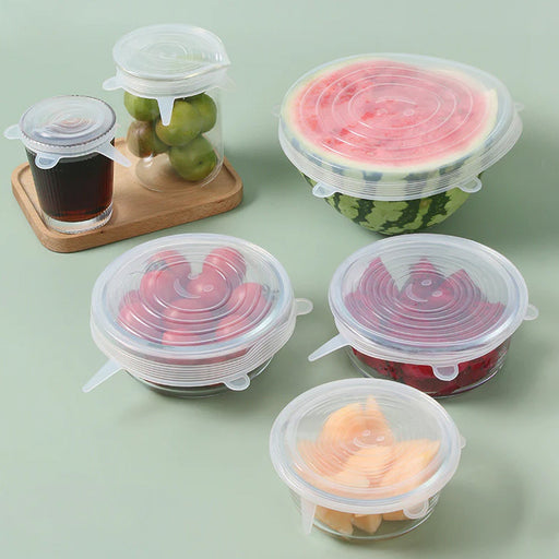 Set of 6 reusable silicone food covers on kitchen table