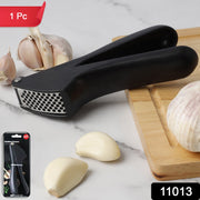 Close-up of manual garlic press crusher tool showing ergonomic design