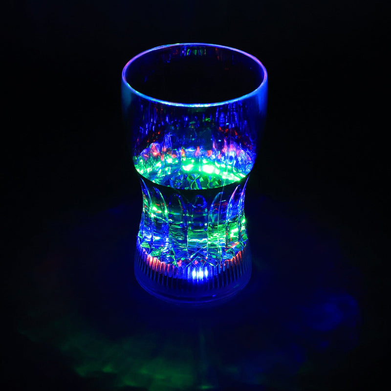 LED Light Glass illuminating a beverage with vibrant colors in a dark setting.