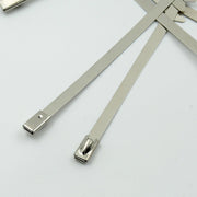 Durable stainless steel cable tie securing electrical wiring in an industrial setting.