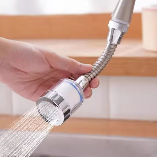Water-saving faucet sprinkler attached to a kitchen sink, demonstrating flexible water flow.