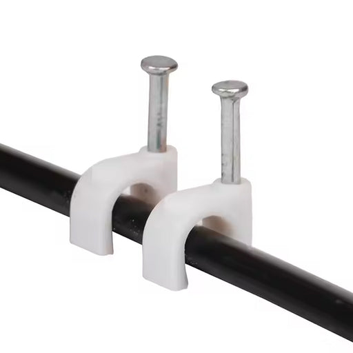 Close-up of plastic U-shaped 8mm nail cable clips with steel nails