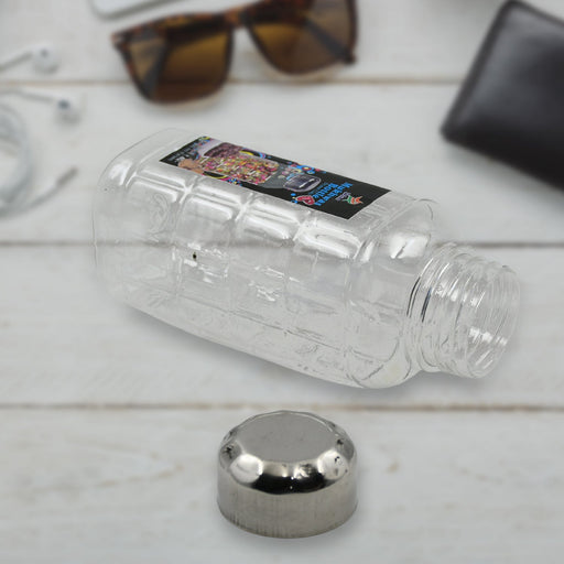 Transparent plastic mukhwas bottle with steel cap on white background