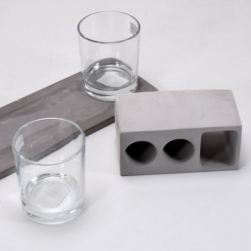 Elegant wine glass holder set with two glasses on a marble base, ideal for home decor.