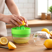 Hand pressing manual citrus juicer extracting juice from orange