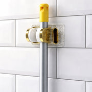 Wall mount mop and broom organizer ideal for kitchen and utility spaces