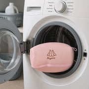 Hand holding the soft 3D air-mesh material of the laundry bag.