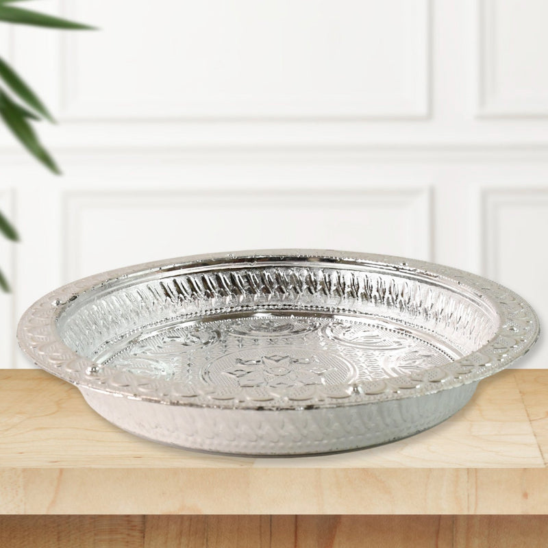 Decorative plastic pooja thali featuring silver finish and floral embossing