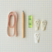 Close-up of wall hanging tools with measuring tape and bubble level