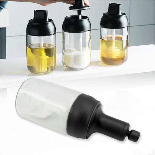A Heat-Resistant Glass Seasoning Jar with integrated spoon, perfect for kitchen use.