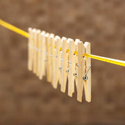 Eco-friendly bamboo cloth clips neatly displayed, highlighting their sustainable material.
