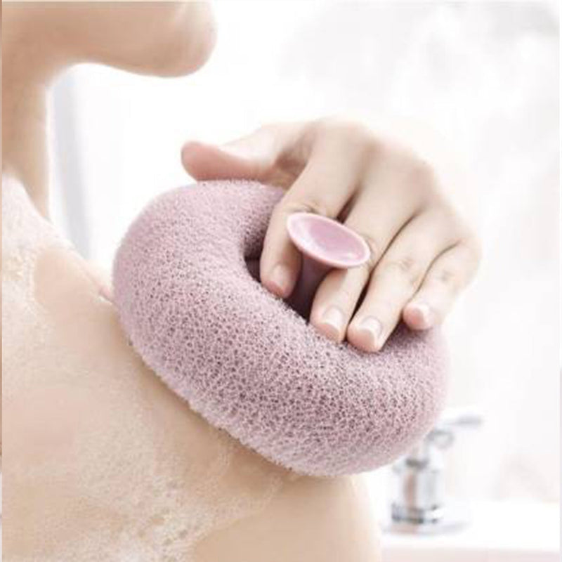 A hand holding the flower-shaped bath sponge during a refreshing shower.
