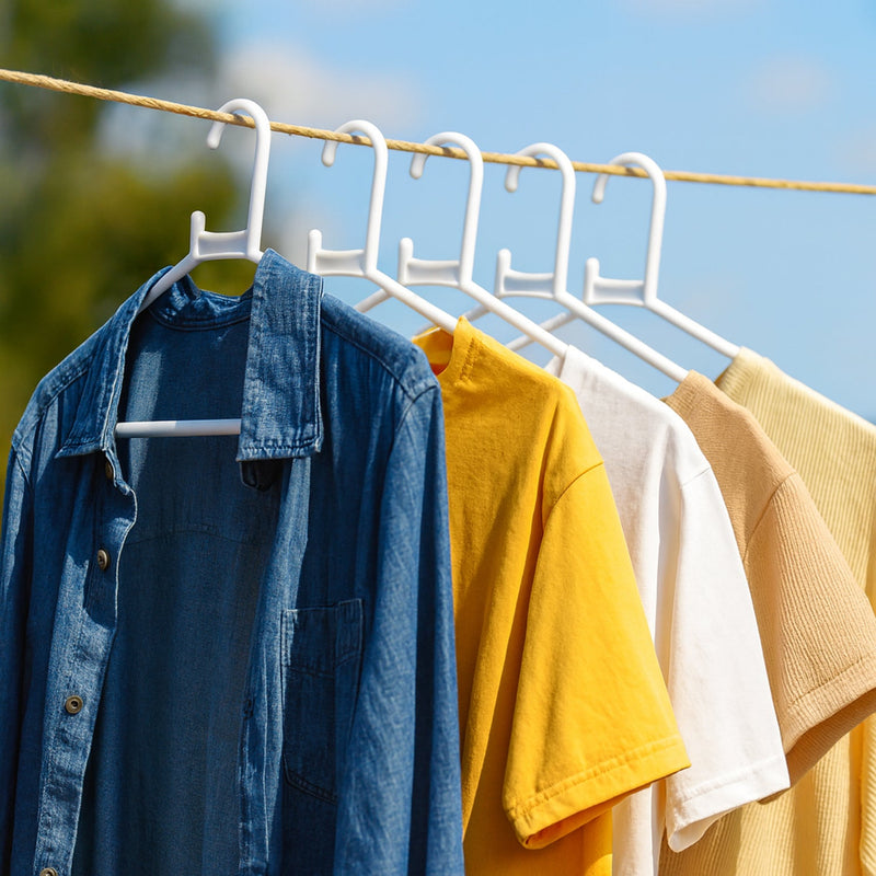 White plastic clothes hanger in practical use inside a closet
