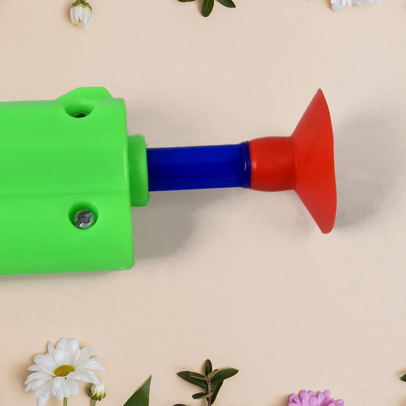 Child's hand holding the toy gun, illustrating how to shoot soft darts safely.