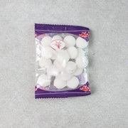 Close-up image of round naphthalene mothball tablets for wardrobe freshness