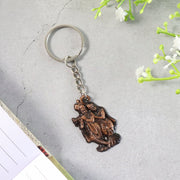 Close-up of Radha Krishna metal keychain showing detailed craftsmanship