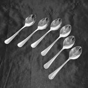 Close-up of elegant polished stainless steel dining spoons