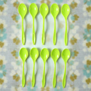A single reusable plastic spoon placed elegantly on a table setting.