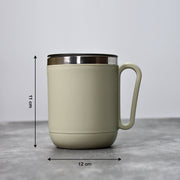 An Indian man enjoying a hot beverage from the Ganesh stainless steel coffee mug.